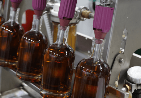 Bottles of aged bourbon on a bottling line